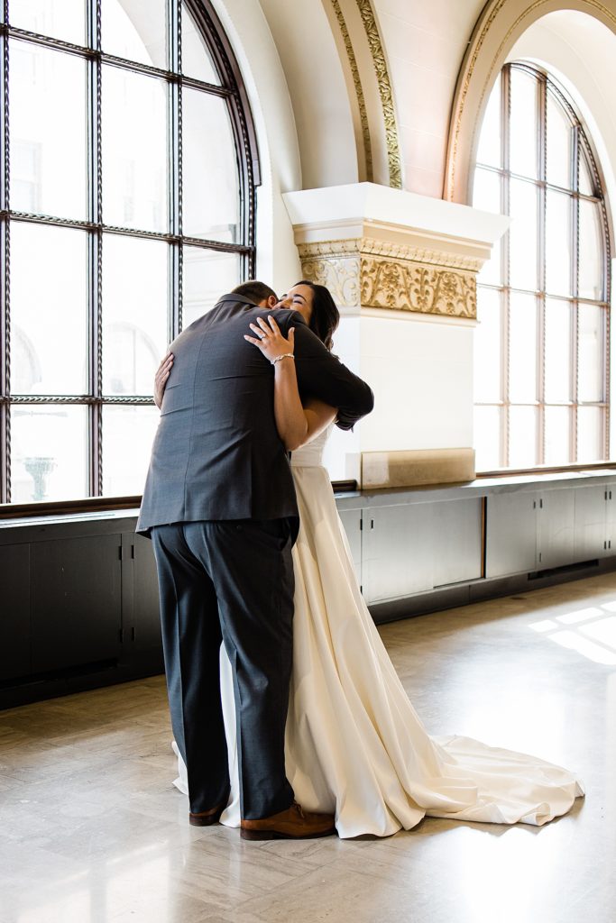 Bride and groom hugging before their wedding ceremony. | Wedding at The Treasury Pontiac, Michigan