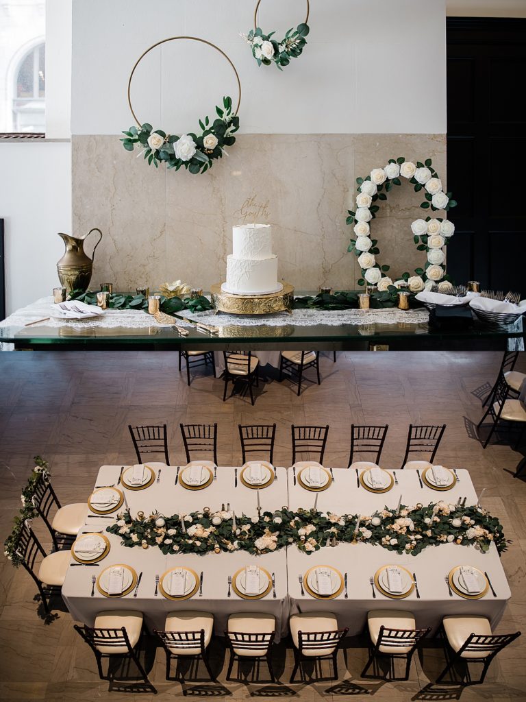 Collage of detail shots from a wedding reception. The cake table with pretty white florals, and a shot from above of a table setting with gold and white details. 