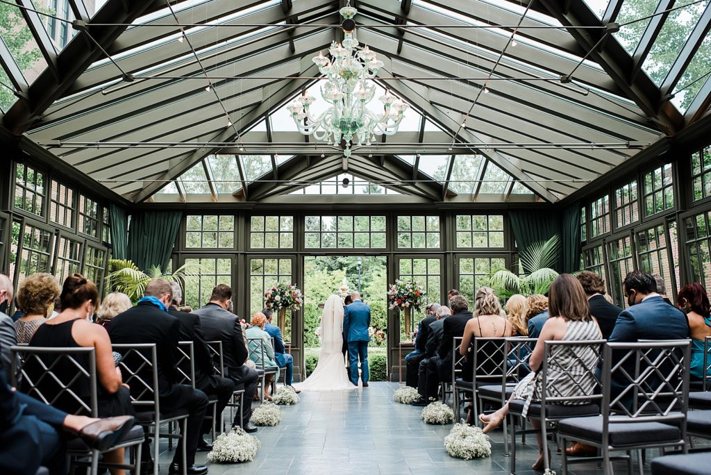 Greenhouse wedding ceremony at The Royal Park Hotel in Rochester Hills.