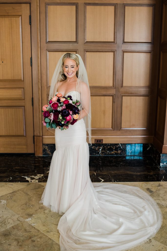 Bride standing in front of ornate door at The Royal Park Hotel in Rochester Hills.