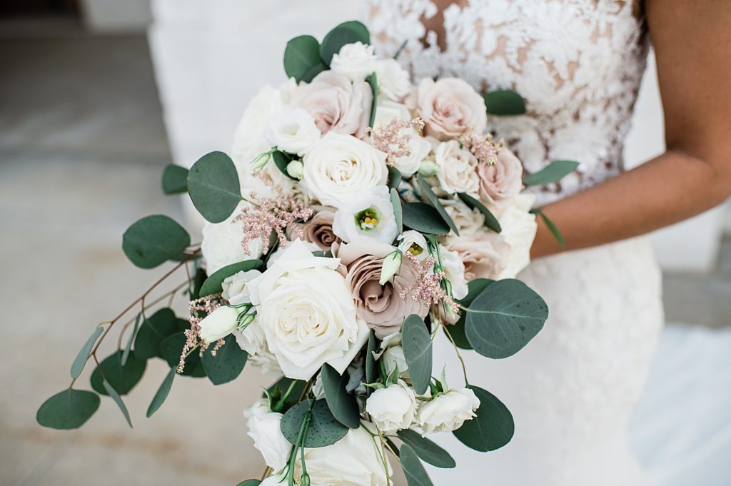 Up close of bridal bouquet of white and dusty rose pink flowers.