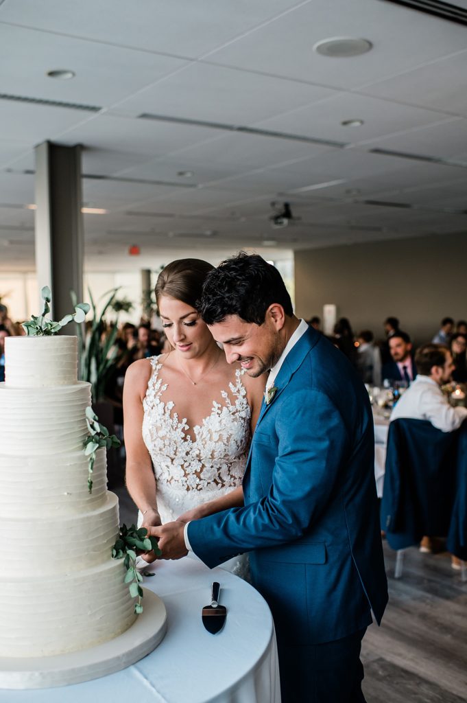 Bride and groom cutting their cake. 