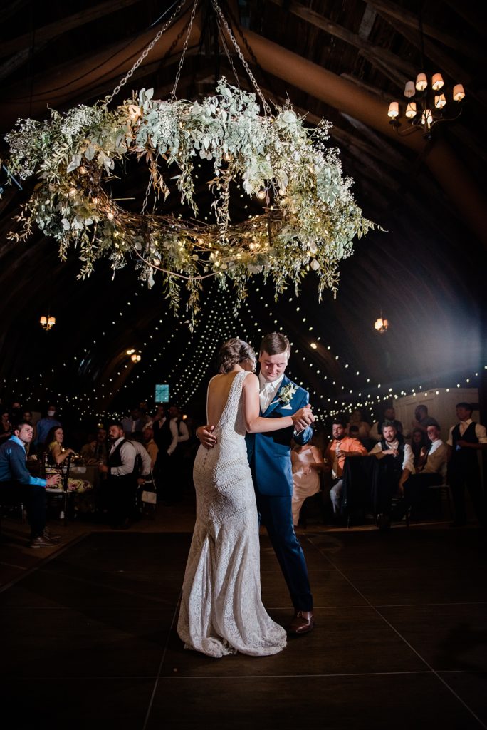 Bride and groom doing their first dance under twinkle lights. 