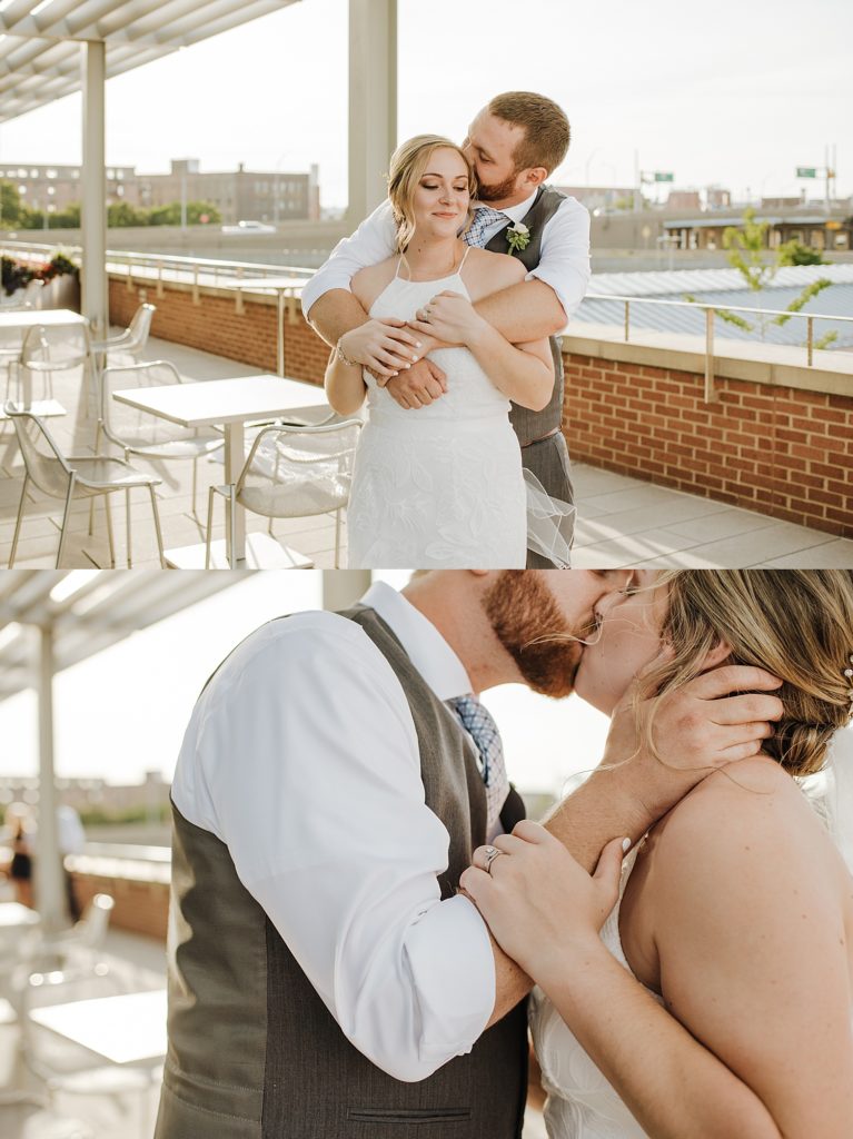 Bride and groom kissing on a rooftop. 