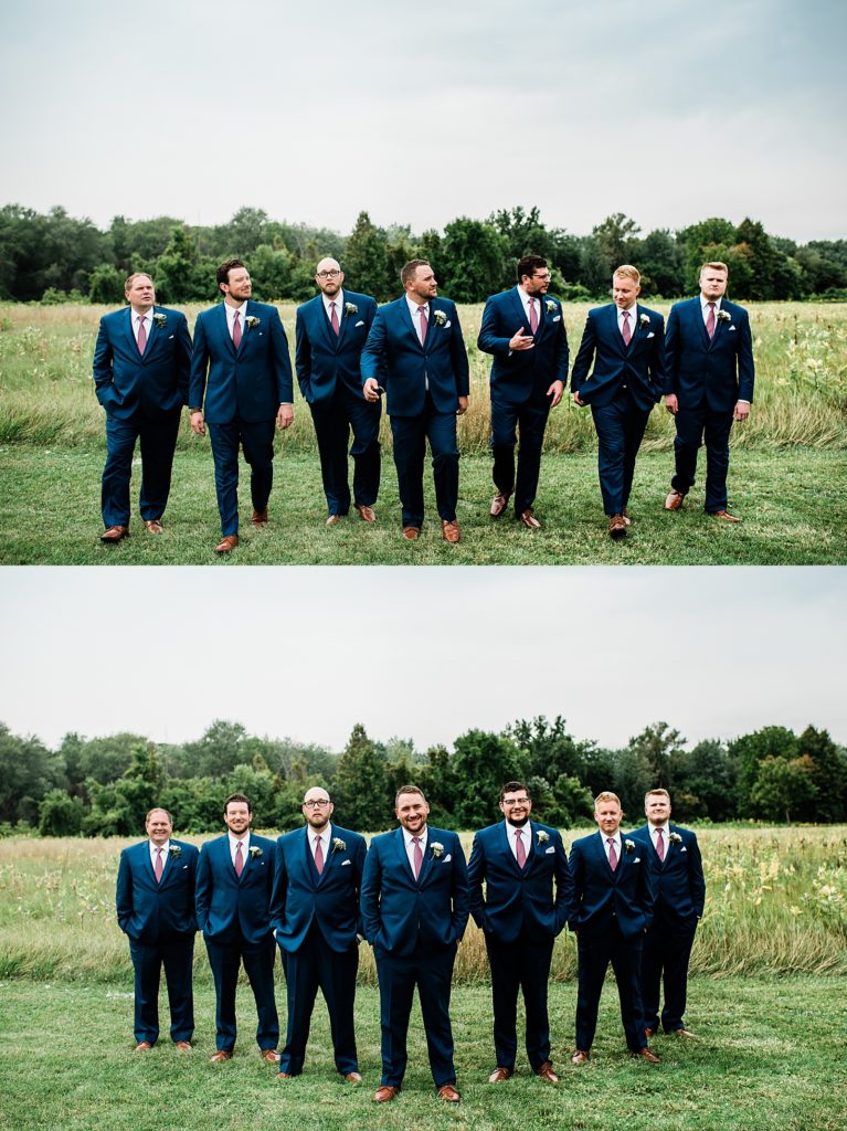 Groom & groomsmen walking towards the camera in a field for this Michigan wedding. 