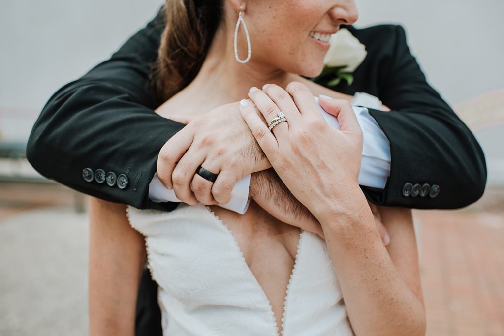 Up close photo of groom holding bride.