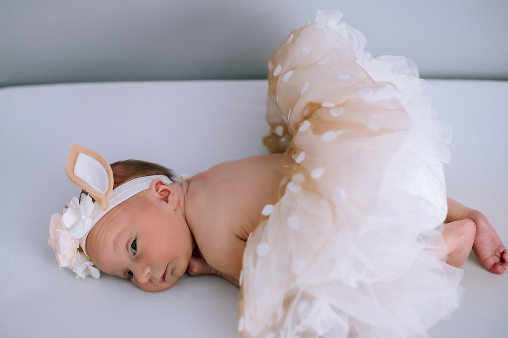 Newborn girl in polka dot tutu and deer ear headband for Michigan lifestyle newborn session. 