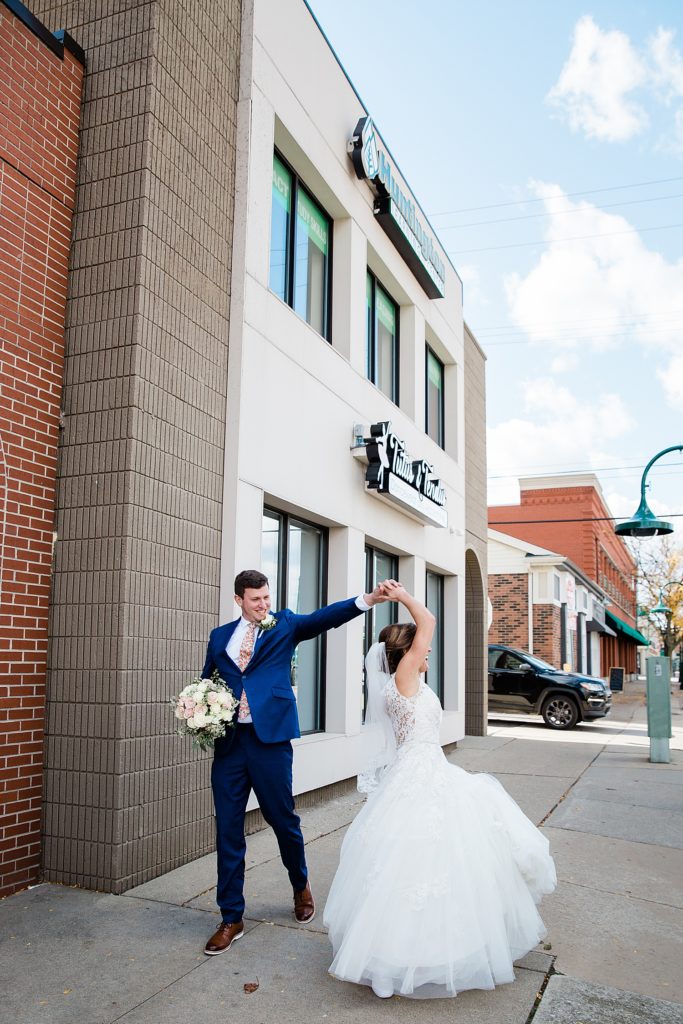 Bride and groom dancing on the street for their Michigan wedding. 