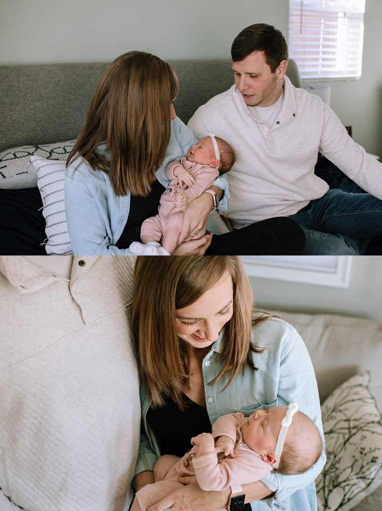 Family sitting on a bed together with their newborn baby daughter for a photo session.