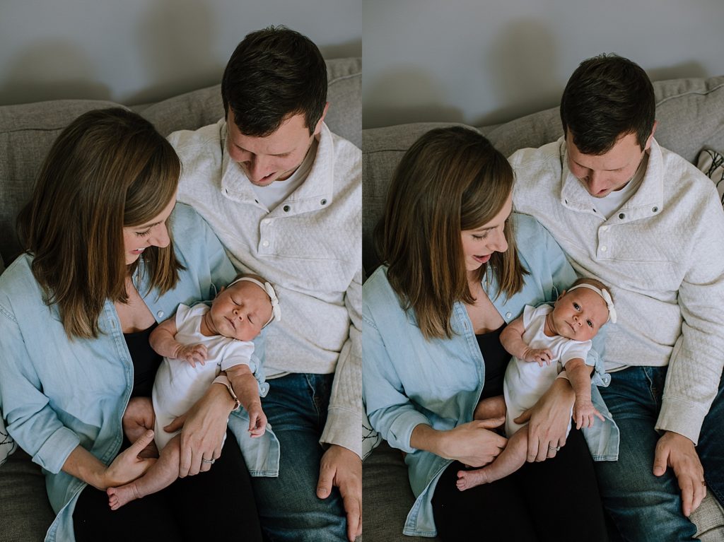 Family of three sitting on their couch with their new daughter for newborn photo shoot.