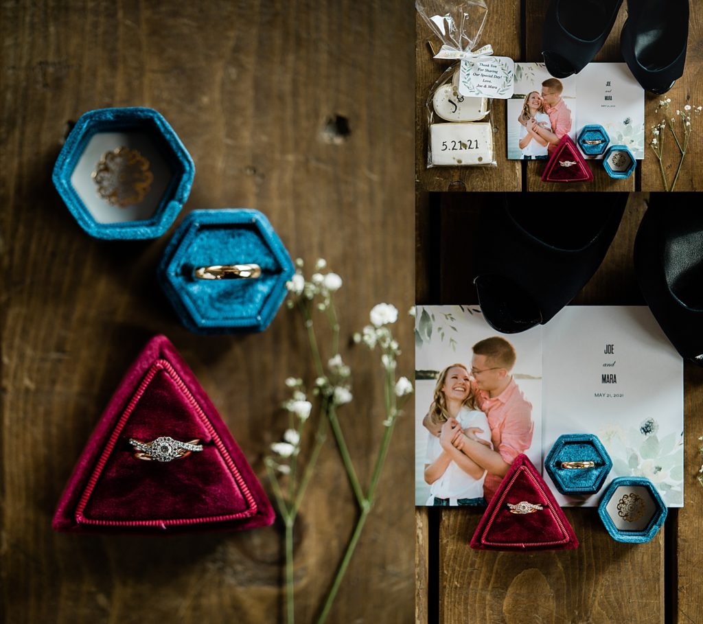 blue and pink ring boxes show off diamond engagement ring and wedding bands