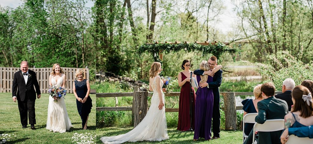 bride walks down the aisle with both father and mother holding colorful wedding bouquet 