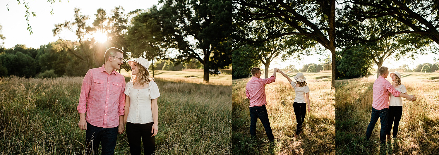couple at sunset in field during engagement session holding hands