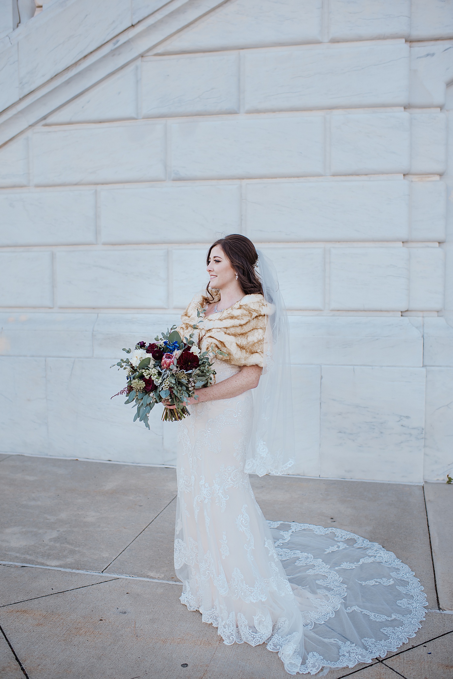 bride has a long train on wedding dress and a long veil 