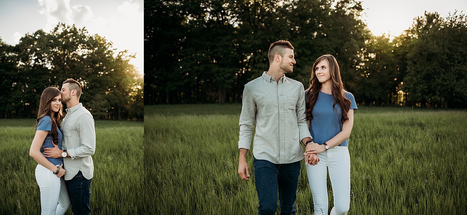 Engaged couple standing in the field on summer day engagement session while holding hands