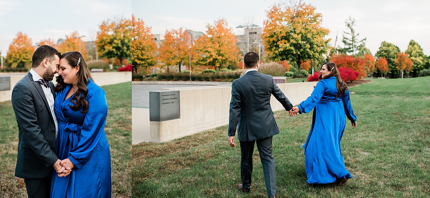 Couple wearing signature wrap blue dress walk the park in Lansing Michigan for engagement session