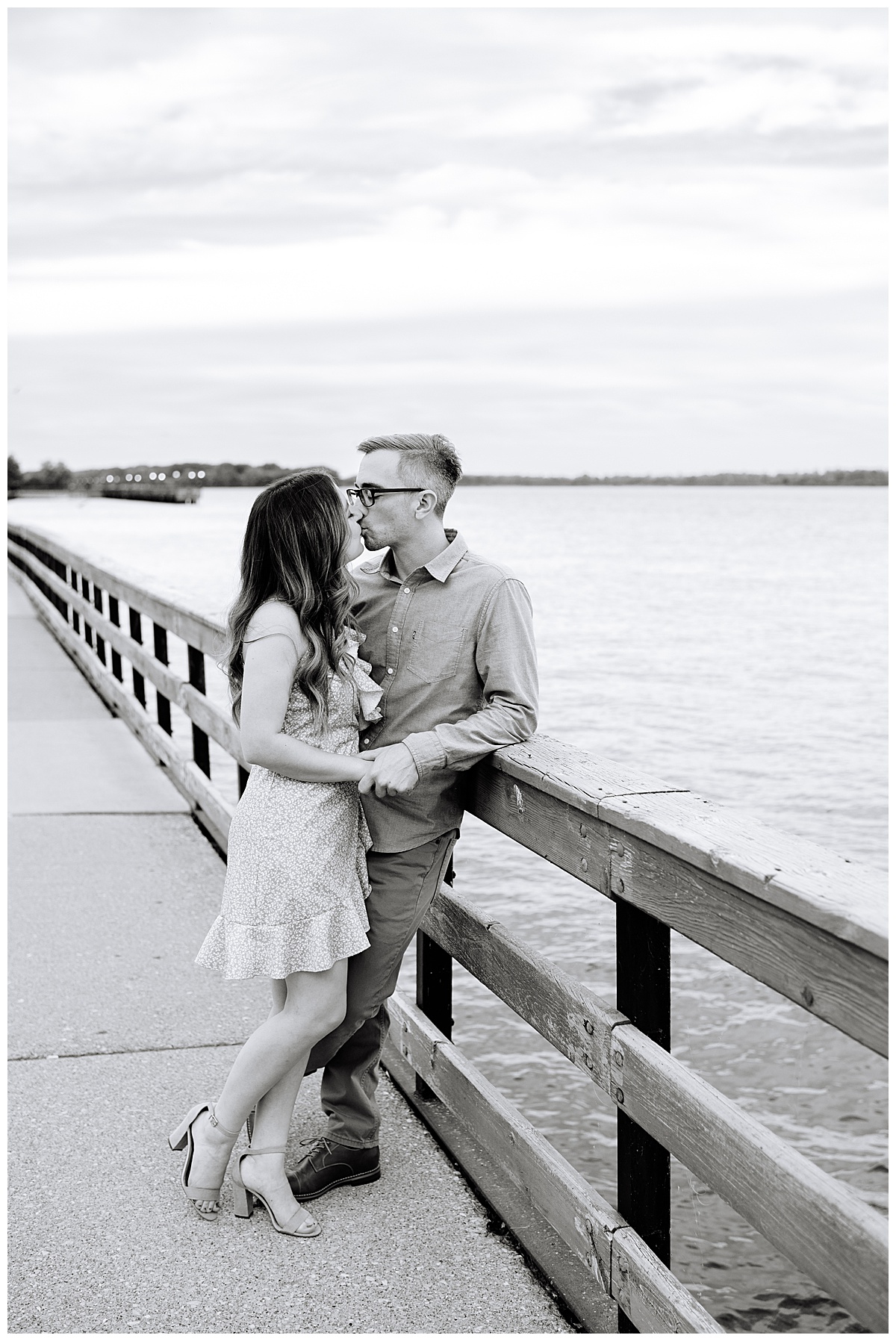 Man and woman kiss on waterfront for Michigan Wedding Photographer