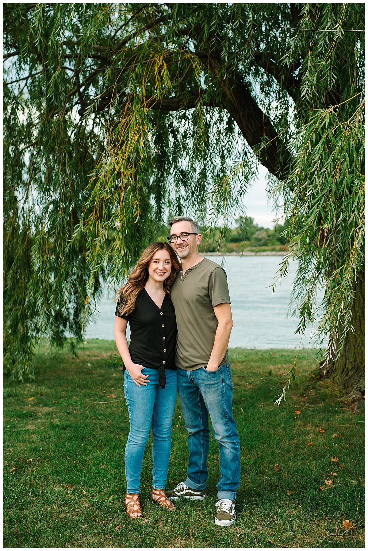 Under tree, couple smiles for Wyandotte engagement session