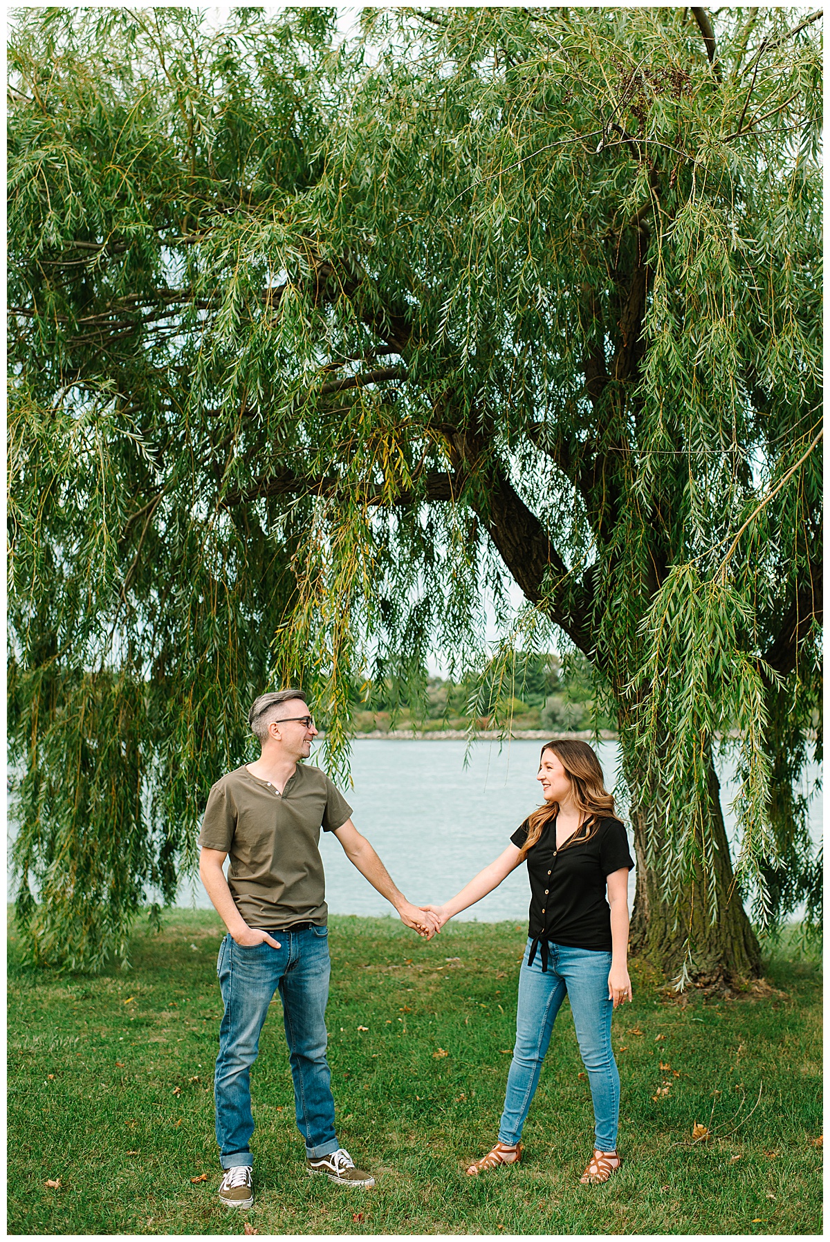 Couple holds hands under tree for Wyandotte engagement session
