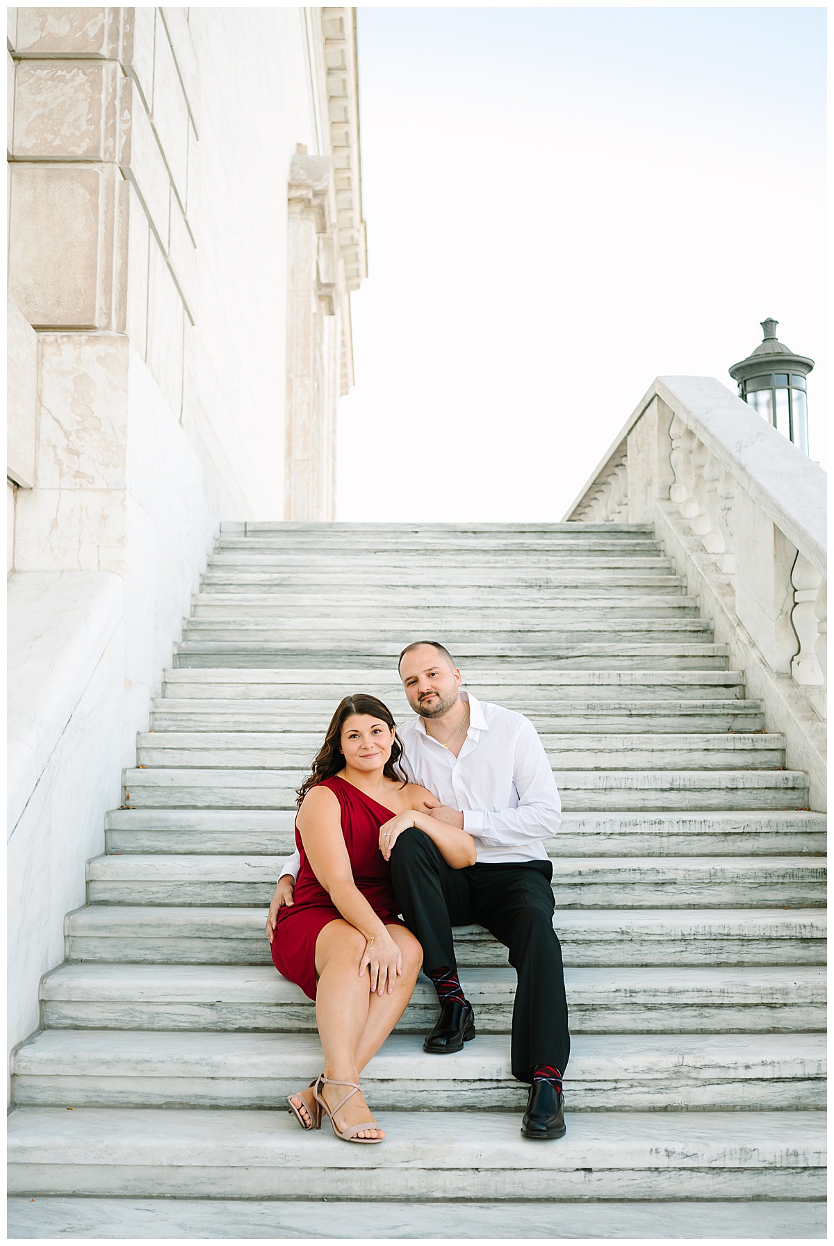 Engaged couple sit on steps for Michigan Wedding Photographer