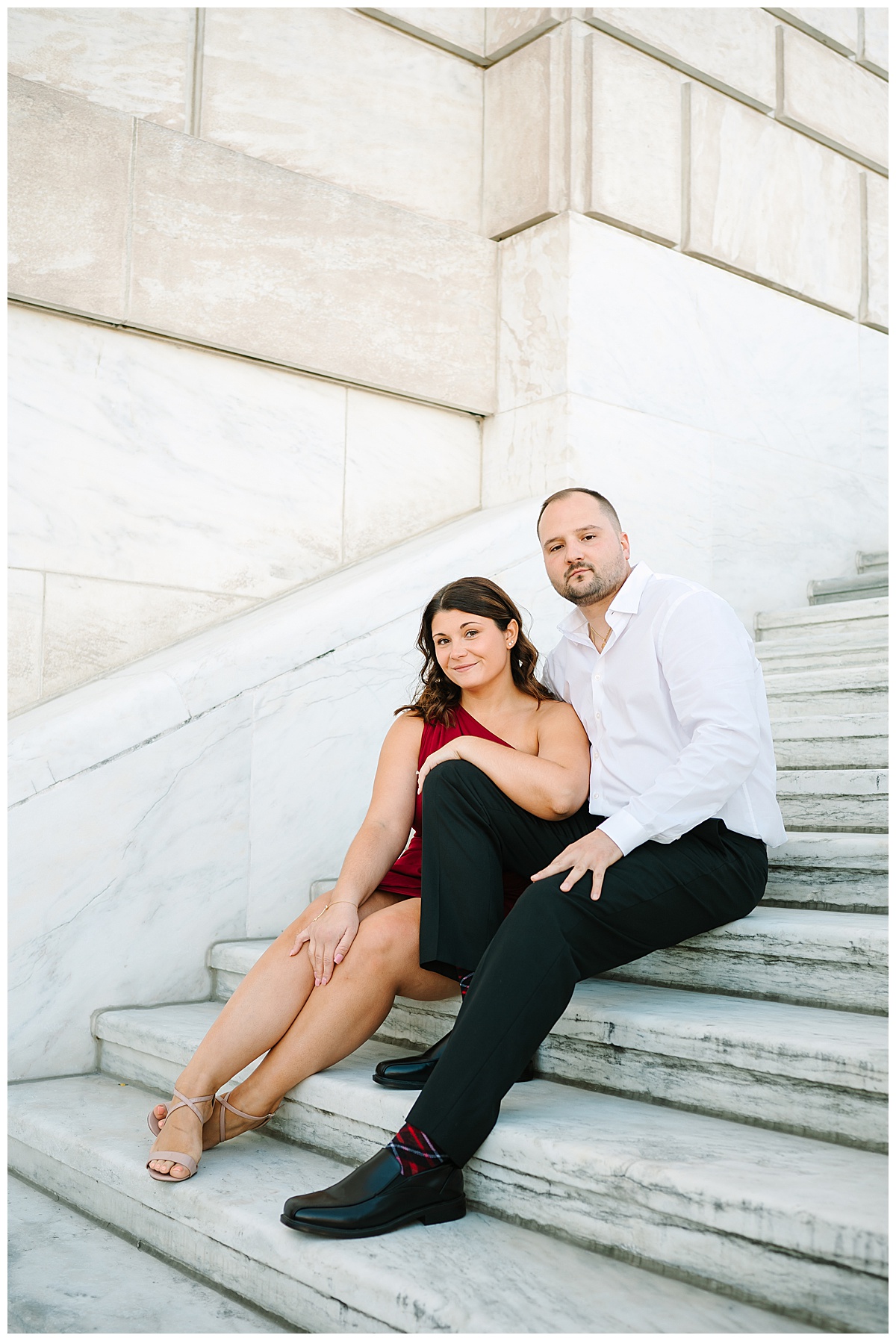 Couple sits beside each other on steps for Michigan Wedding Photographer