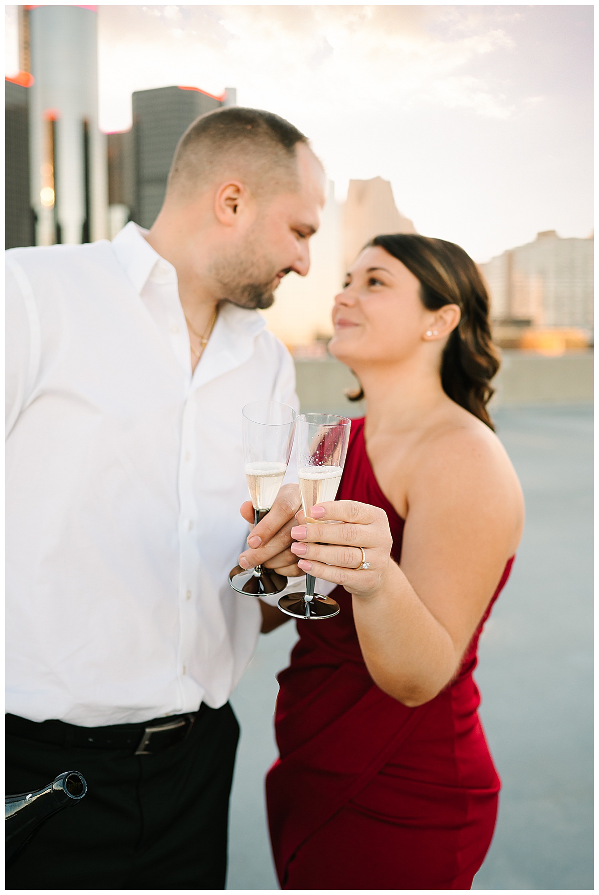 Fiancés toasting to each other for Detroit Engagement Session