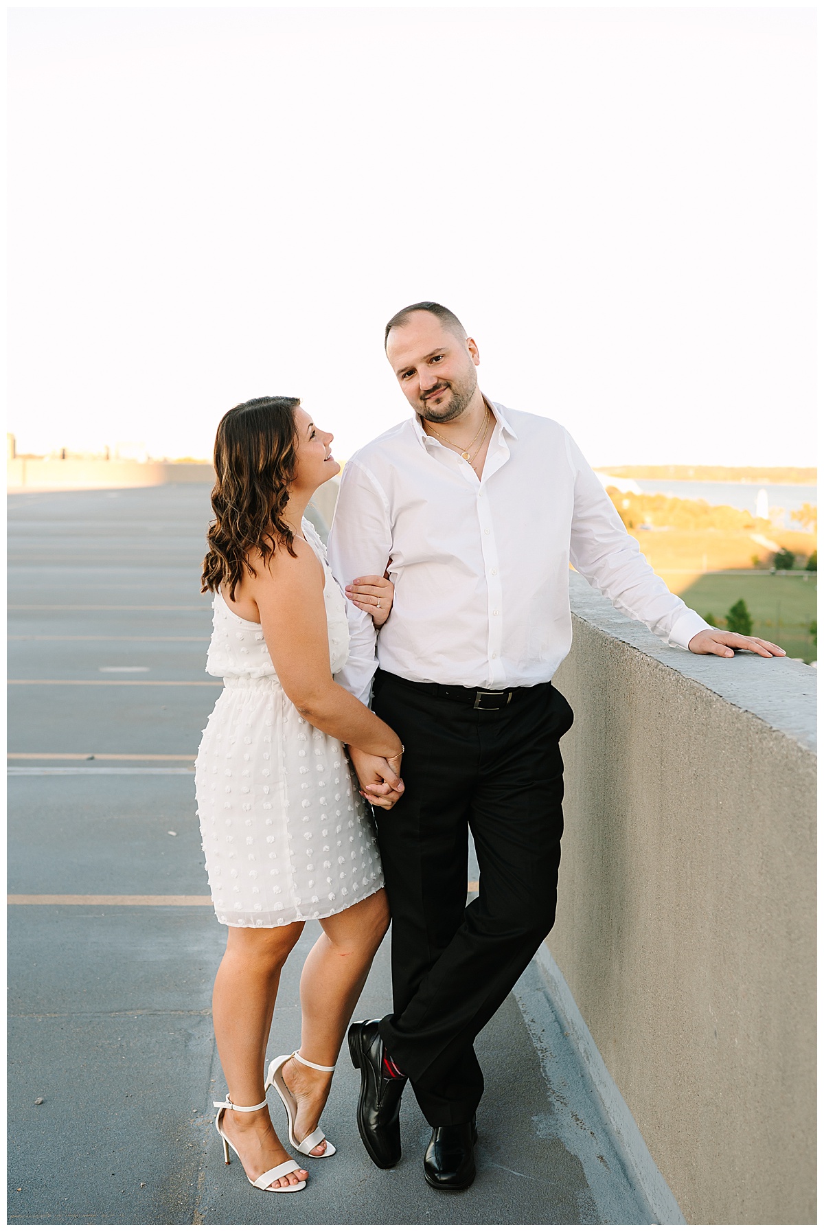 Woman holds mans arm for Detroit Engagement Session