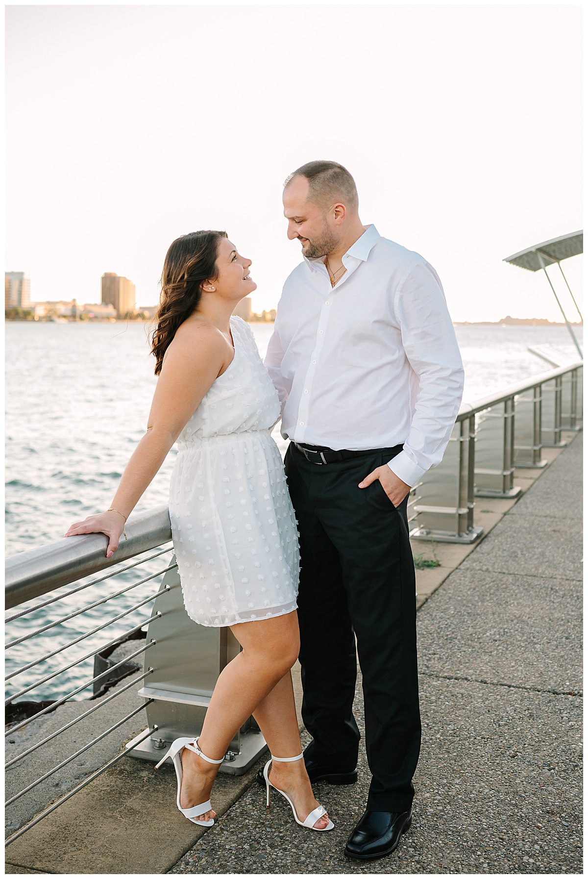 Fiancés looking at each other by water for Detroit Engagement Session
