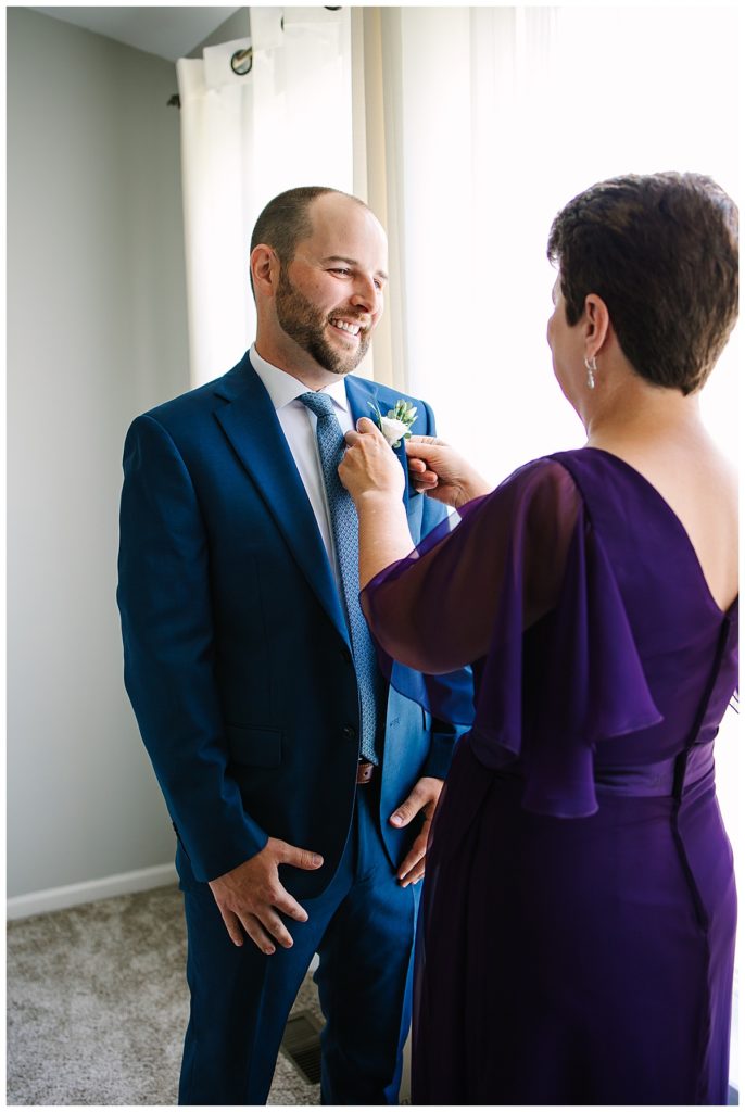 Mother adjusting groom's flower for Michigan Wedding Photographer