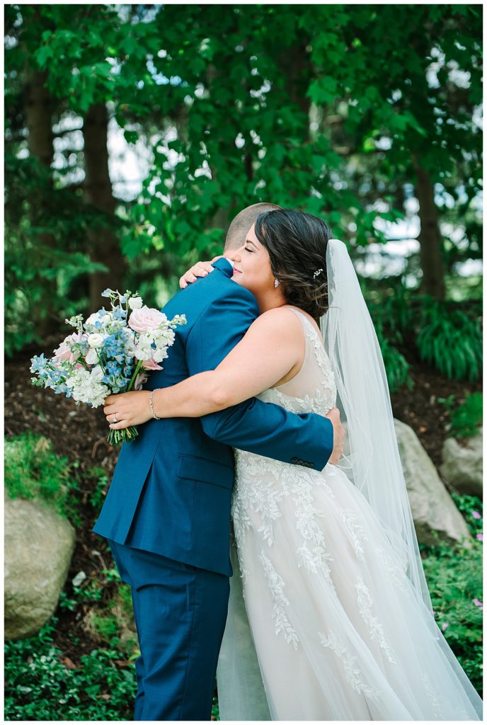 Bride hugging groom for Michigan Wedding Photographer