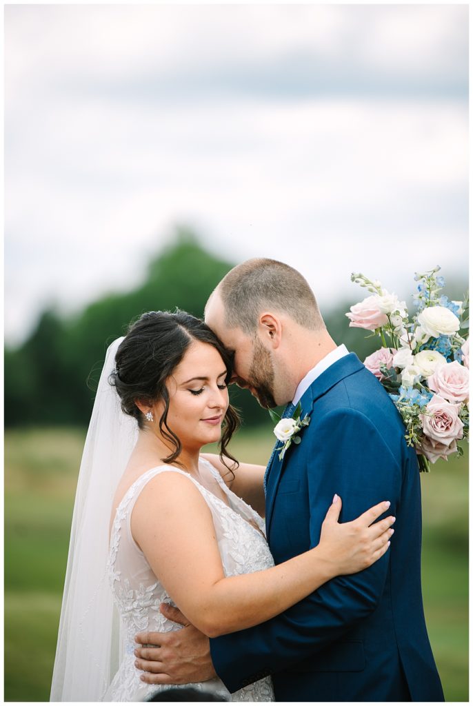 Newlyweds embracing in a hug for Michigan Wedding Photographer