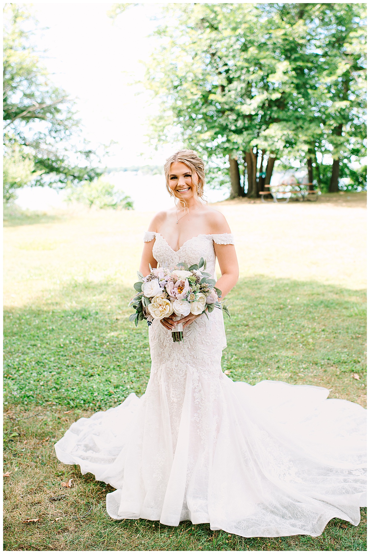 Bride stands in grass for Brittany Emerson Photography