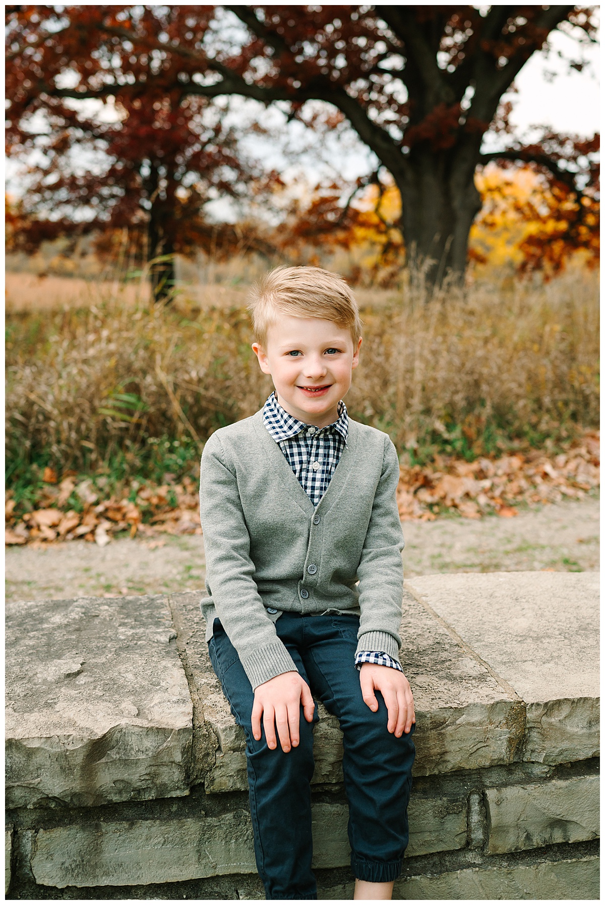 Young boy smiles big for White Lake Family Photographer