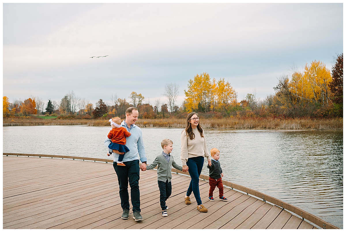 Parents and kids walk near waterfront for White Lake Family Photographer