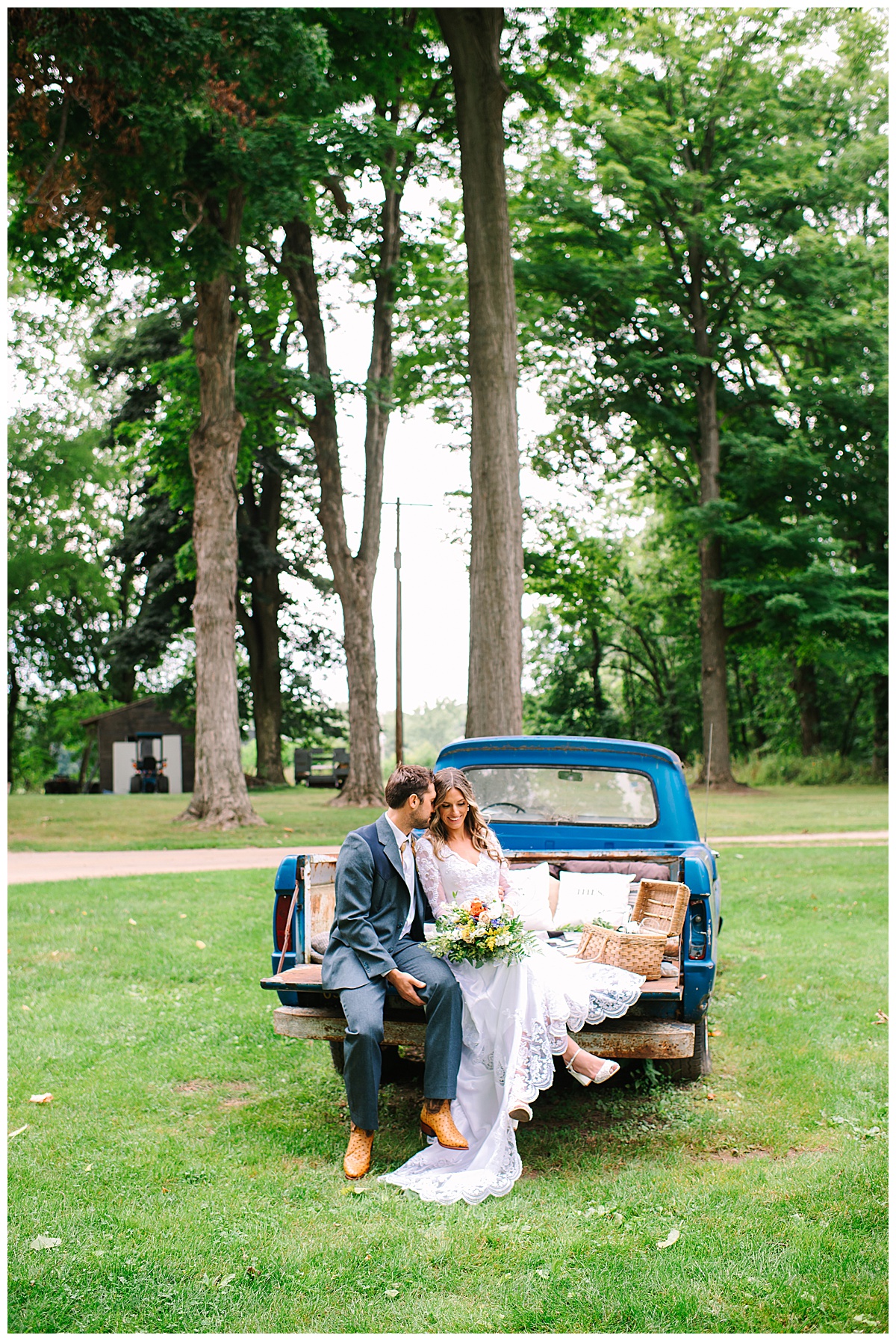 couple sit on truck bed for Michigan Wedding Photographer