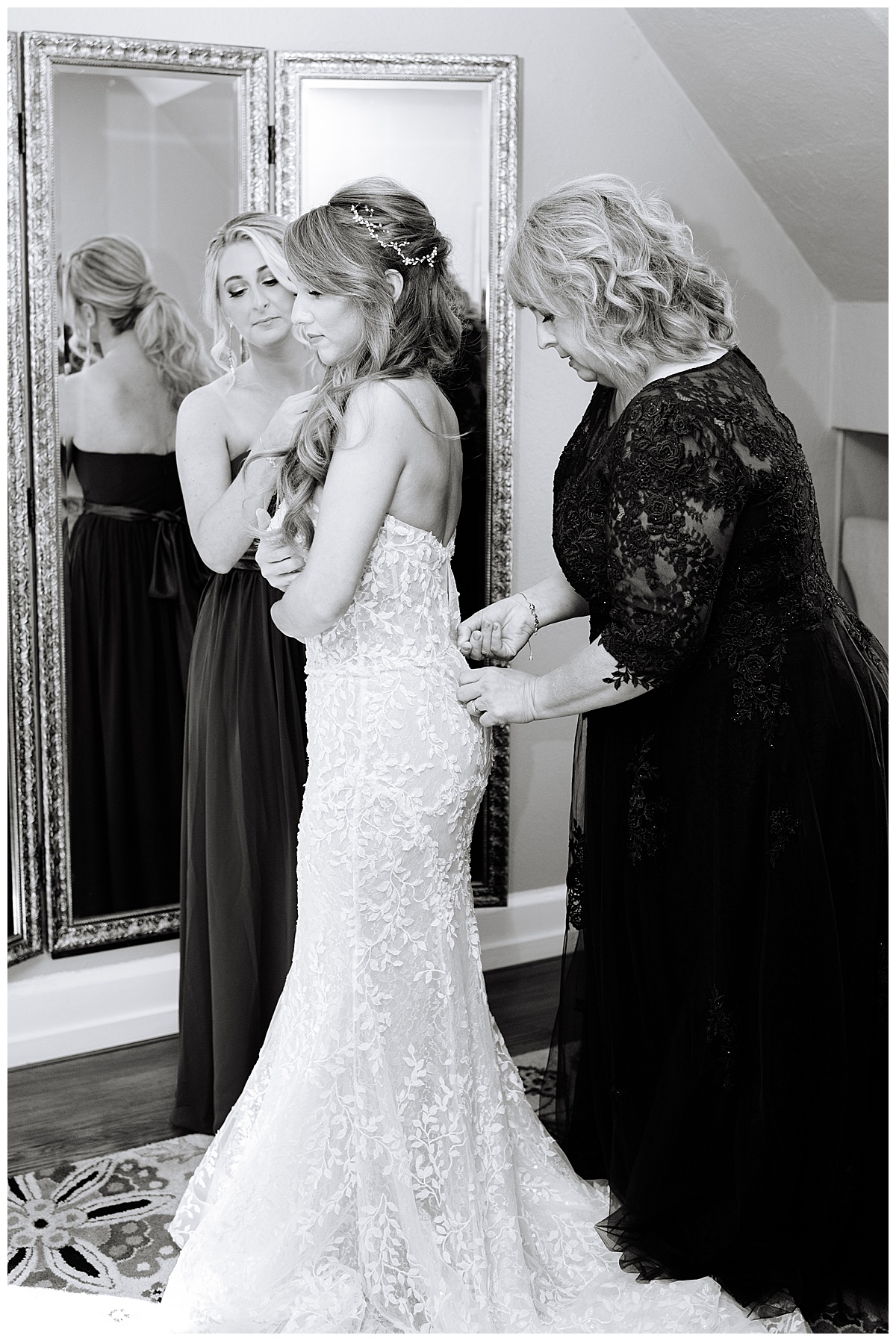 Mother helps daughter with bridal gown for Michigan Wedding Photographer