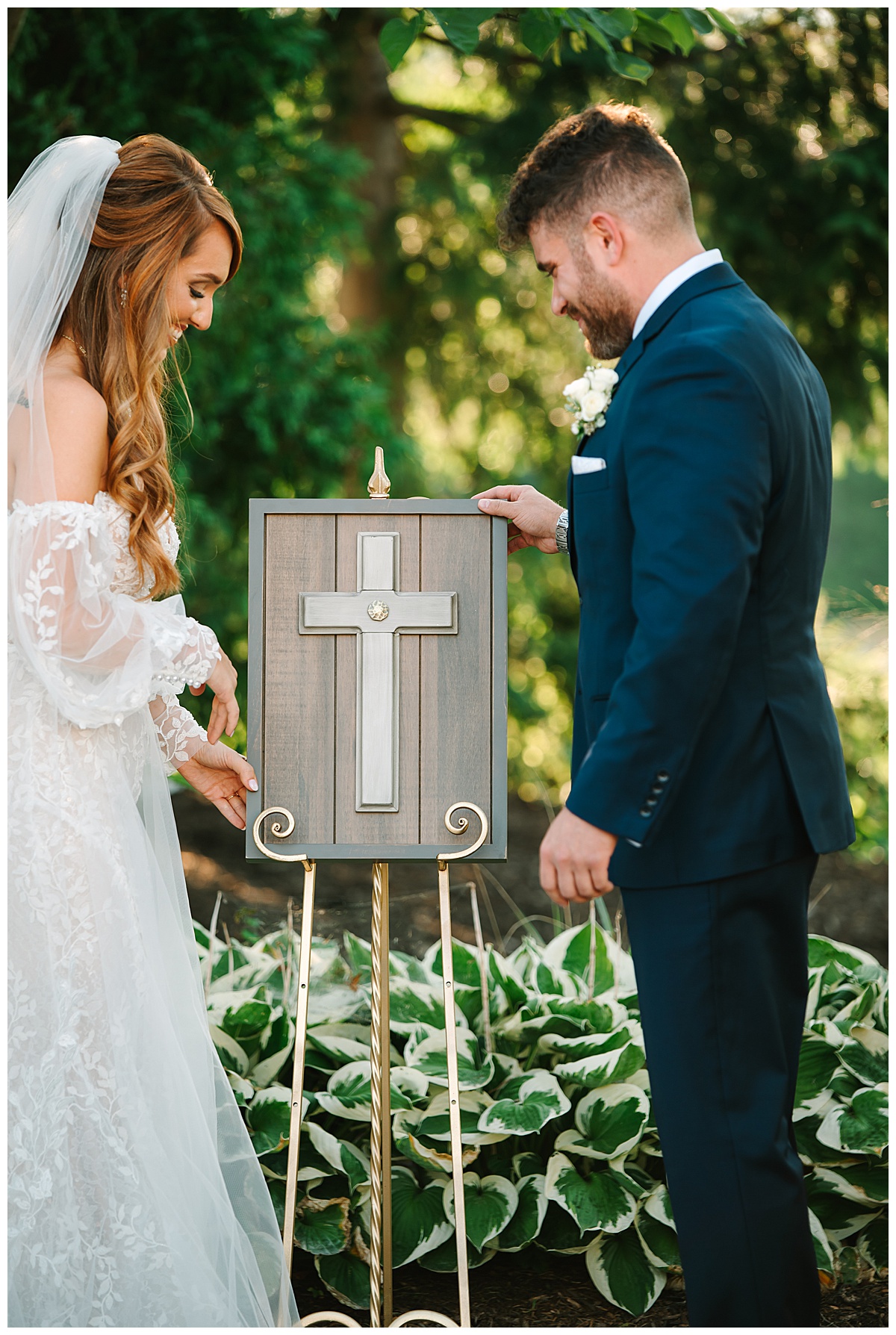 Man and woman stare at beautiful cross for Michigan Wedding Photographer