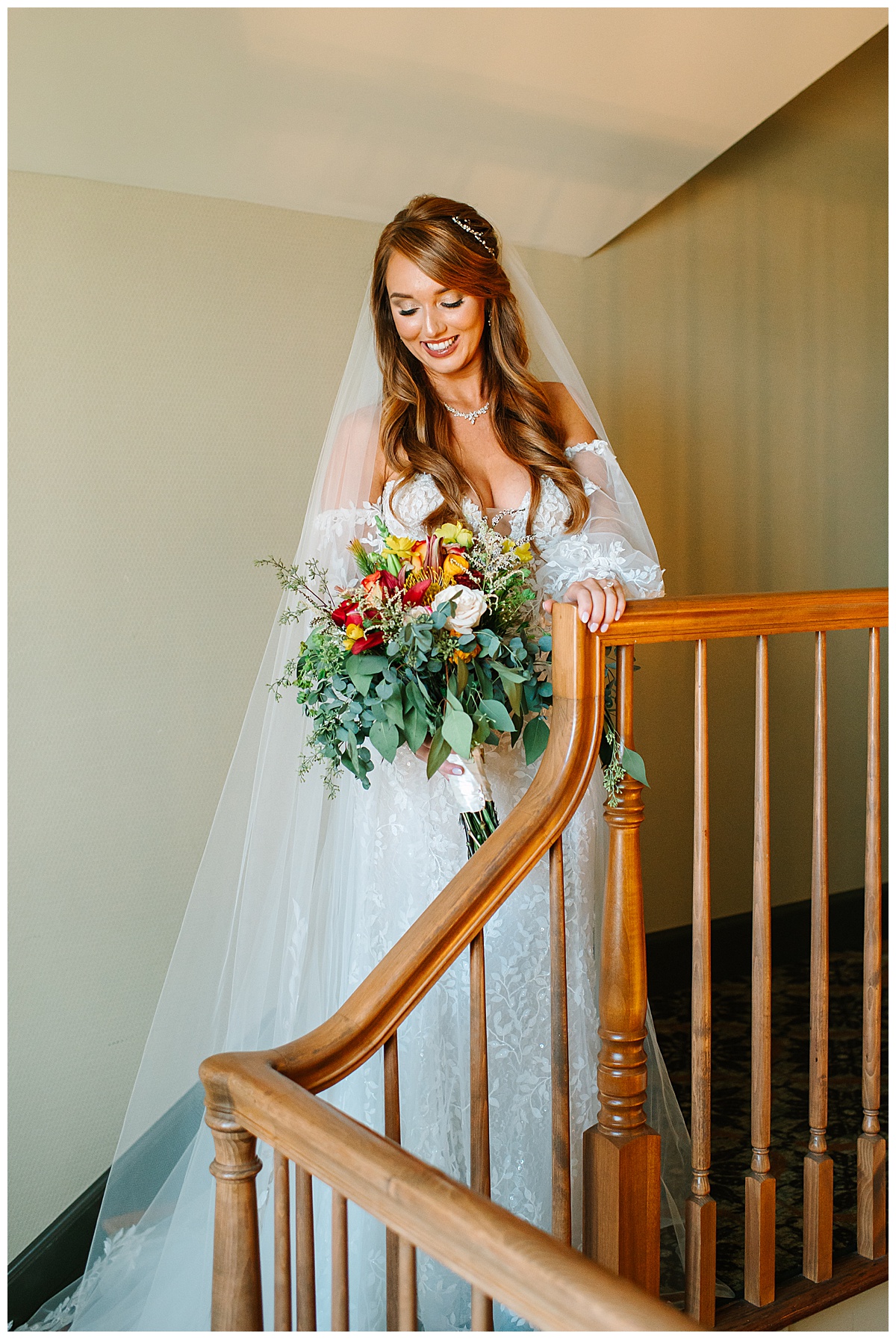 Bride stands on staircase for Glen Oaks wedding