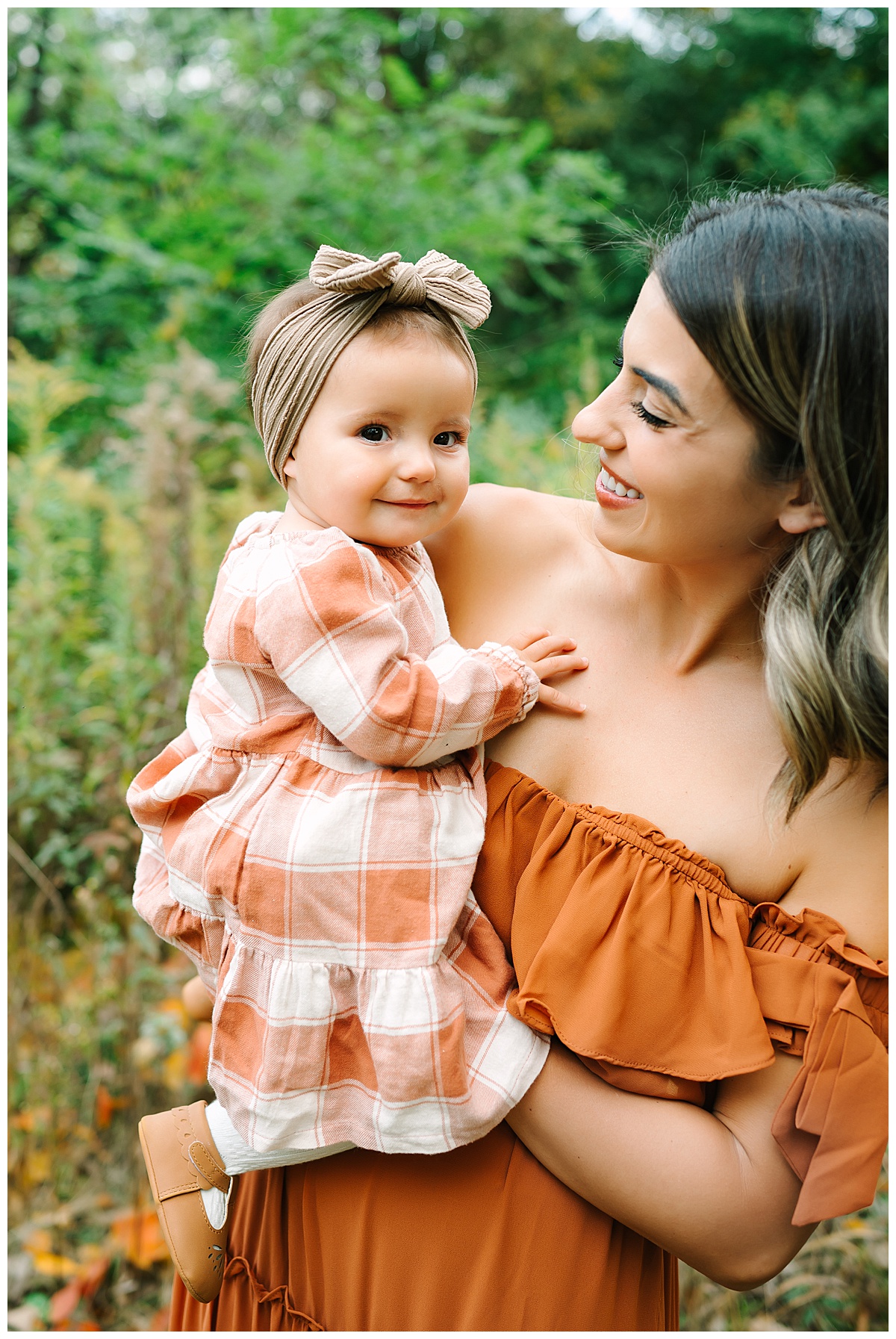 Daughter smiles next to mom for Brittany Emerson Photography