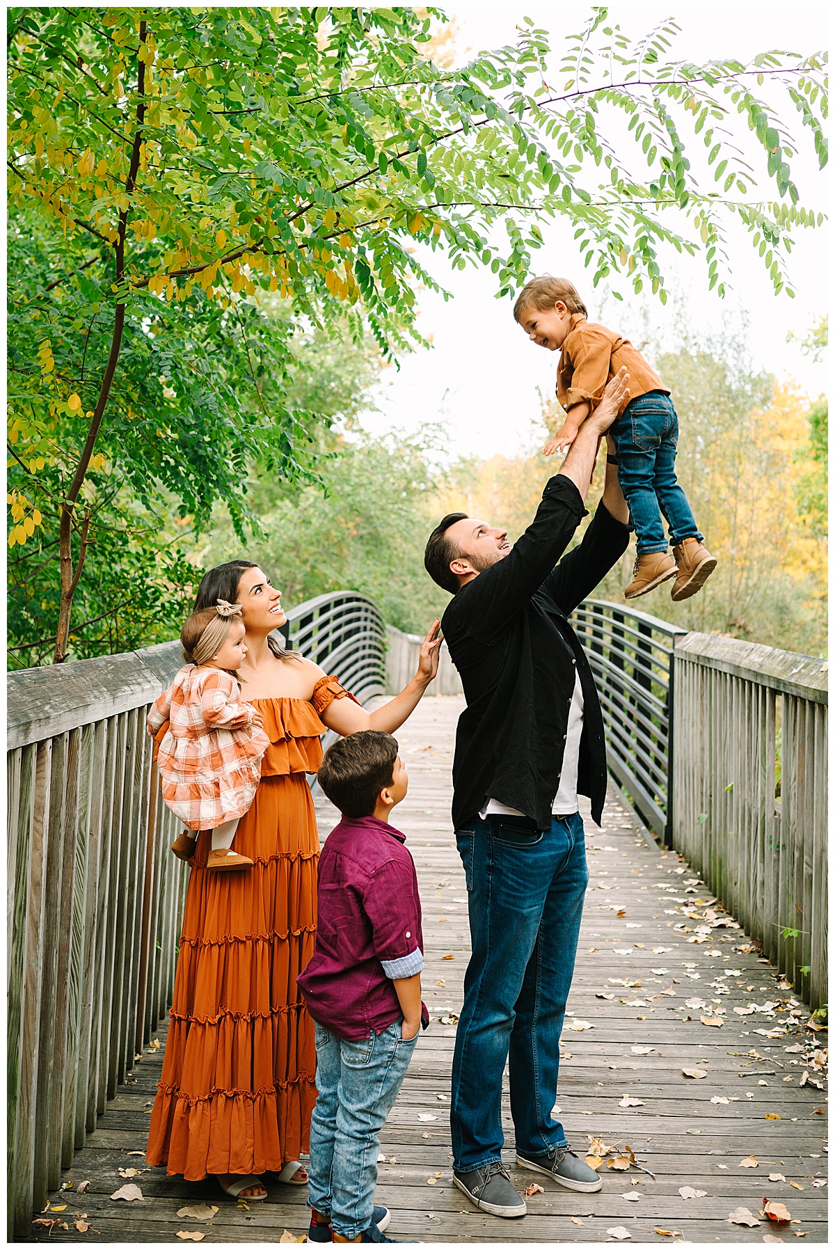 Dad tossing son into air for Brittany Emerson Photography