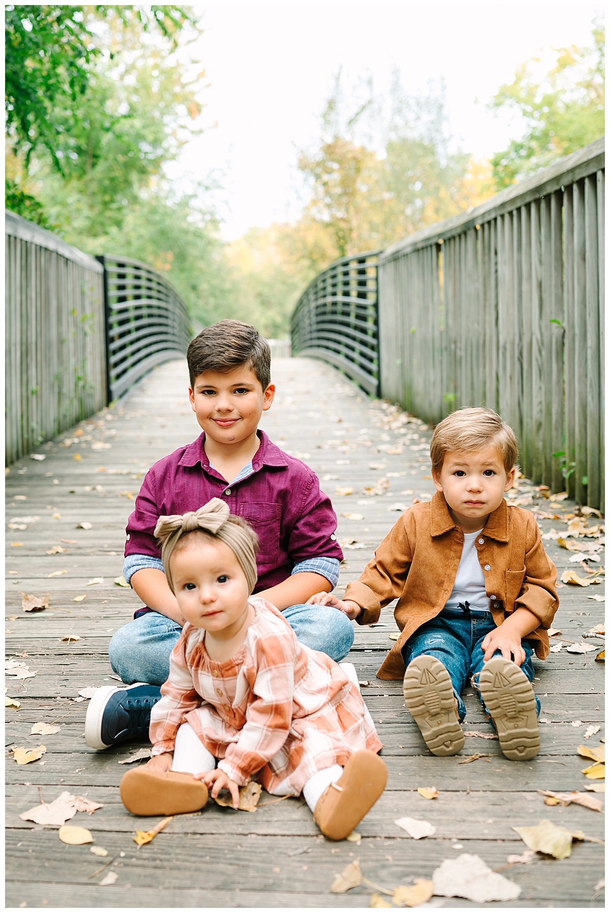 Kids sitting on bridge for Oakland County Family Session